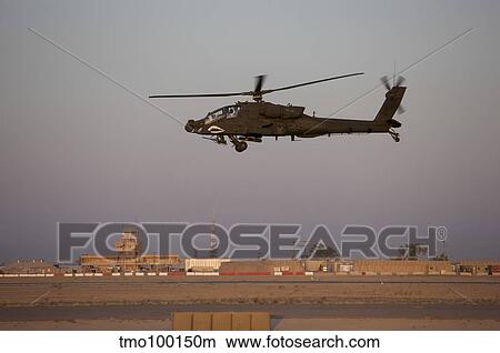 Picture - An AH-64D Apache Longbow Block III flies by the control tower on Camp Speicher.. Fotosearch