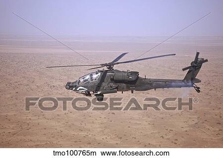 An AH-64D Apache Longbow fires a hydra rocket over Iraq. View Large Photo Image Picture - An AH-64D Apache Longbow fires a hydra rocket over Iraq.. Fotosearch