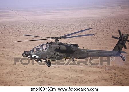 An AH-64D Apache Longbow fires a hydra rocket over Iraq. View Large Photo Image Picture - An AH-64D Apache Longbow fires a hydra rocket over Iraq.. Fotosearch