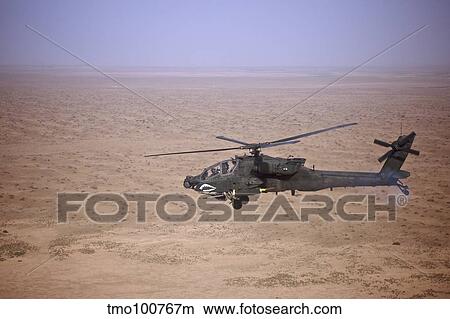 An AH-64D Apache Longbow fires a hydra rocket over Iraq. View Large Photo Image Picture - An AH-64D Apache Longbow fires a hydra rocket over Iraq.. Fotosearch