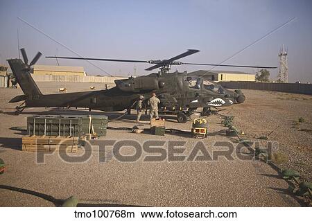 An AH-64D Apache Longbow receives fuel at a military base in Iraq. View Large Photo Image Picture - An AH-64D Apache Longbow receives fuel at a military base in Iraq.. Fotosearch