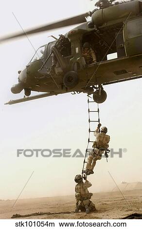 An Air Force HH-60G Pavehawk deploys pararescuemen. View Large Photo Image Picture - An Air Force HH-60G Pavehawk deploys pararescuemen.. Fotosearch
