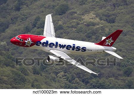 An Airbus A320 of Edelweiss Air in flight over Locarno, Switzerland. View Large Photo Image Picture - An Airbus A320 of Edelweiss Air in flight over Locarno, Switzerland.. Fotosearch
