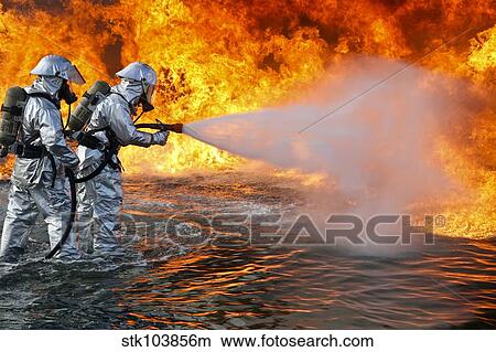 An aircraft rescue firefighting team attempts to spray out a fuel fire. View Large Photo Image Picture - An aircraft rescue firefighting team attempts to spray out a fuel fire.. Fotosearch