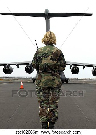 An airfield manager greets an arriving C-17 Globemaster III. View Large Photo Image Picture - An airfield manager greets an arriving C-17 Globemaster III.. Fotosearch