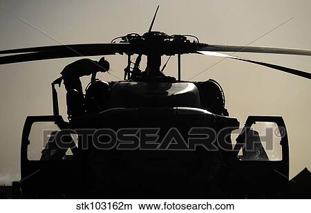 An Airman conducting a preflight inspection of an HH-60G Pave Hawk. View Large Photo Image Picture - An Airman conducting a preflight inspection of an HH-60G Pave Hawk.. Fotosearch