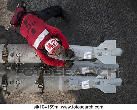 An airman moves ordnance on the flight deck of the aircraft carrier USS Carl Vinson. View Large Photo Image Picture - An airman moves ordnance on the flight deck of the aircraft carrier USS Carl Vinson.. Fotosearch