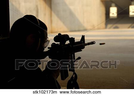 An Airman tests his skills at the shooting range. View Large Photo Image Picture - An Airman tests his skills at the shooting range.. Fotosearch
