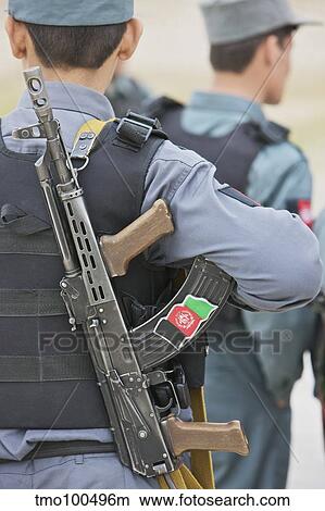 An AK-47 rests on the sling of an Afghan Police Officer. View Large Photo Image Picture - An AK-47 rests on the sling of an Afghan Police Officer.. Fotosearch