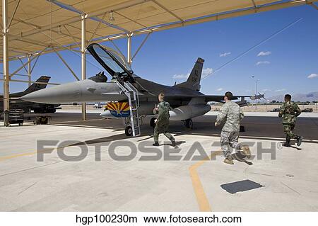An alert crew scrambles to an F-16 to prepare it for takeoff. View Large Photo Image Picture - An alert crew scrambles to an F-16 to prepare it for takeoff.. Fotosearch