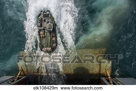 An amphibious assault vehicle exits the well deck of USS Bataan. View Large Photo Image Picture - An amphibious assault vehicle exits the well deck of USS Bataan.. Fotosearch