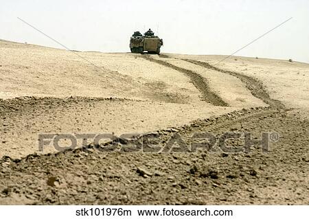 An amphibious assault vehicle rolls through a desert field. View Large Photo Image Picture - An amphibious assault vehicle rolls through a desert field.. Fotosearch