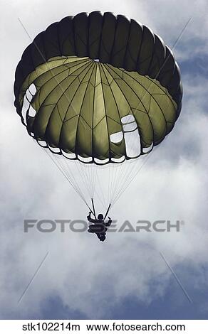 An Armed Forces of the Philippines paratrooper wearing an MC1-C parachute descends through the sky. View Large Photo Image Picture - An Armed Forces of the Philippines paratrooper wearing an MC1-C parachute descends through the sky.. Fotosearch