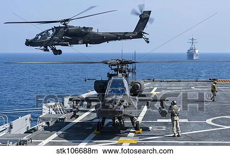 An Army AH-64D Apache helicopter takes off from USS Ponce. View Large Photo Image Picture - An Army AH-64D Apache helicopter takes off from USS Ponce.. Fotosearch