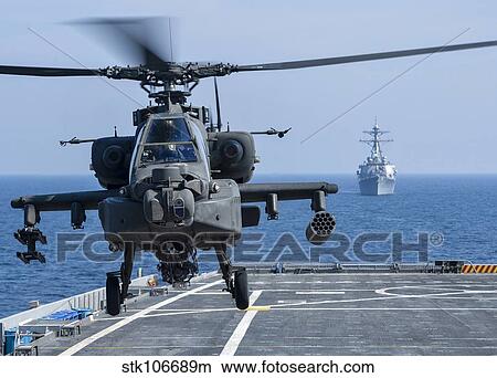 An Army AH-64D Apache helicopter takes off from USS Ponce. View Large Photo Image Picture - An Army AH-64D Apache helicopter takes off from USS Ponce.. Fotosearch