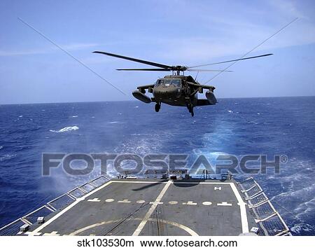 An Army UH-60 Black Hawk helicopter landing aboard the USS Underwood off the coast of Honduras. View Large Photo Image Picture - An Army UH-60 Black Hawk helicopter landing aboard the USS Underwood off the coast of Honduras.. Fotosearch