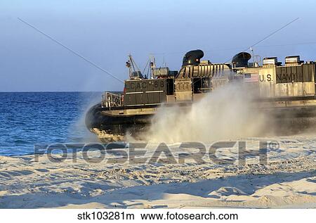 An assault craft heads back to sea after dropping off cargo during an offload. View Large Photo Image Picture - An assault craft heads back to sea after dropping off cargo during an offload.. Fotosearch