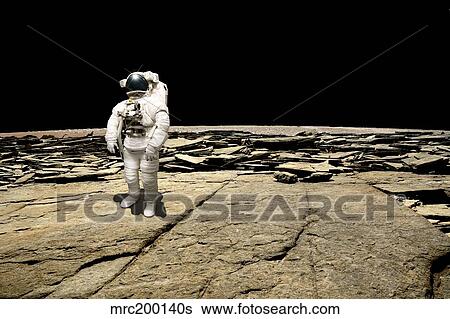Stock Photograph - An astronaut on a barren planet.. Fotosearch