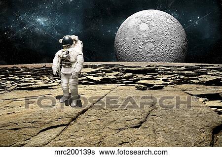 Stock Photograph - An astronaut on a barren planet with moon rising over the horizon.. Fotosearch