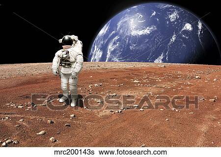 Stock Photograph - An astronaut standing on a barren world with planet rising in background.. Fotosearch