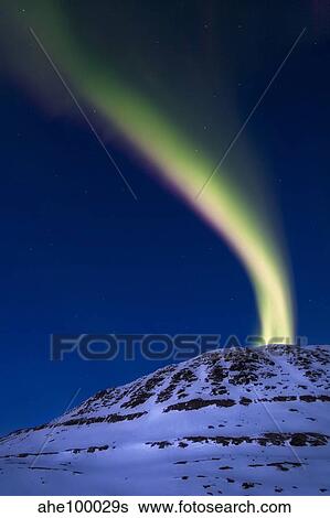 An aurora borealis shooting up from Toviktinden Mountain, Norway. View Large Photo Image Stock Photograph - An aurora borealis shooting up from Toviktinden Mountain, Norway.. Fotosearch