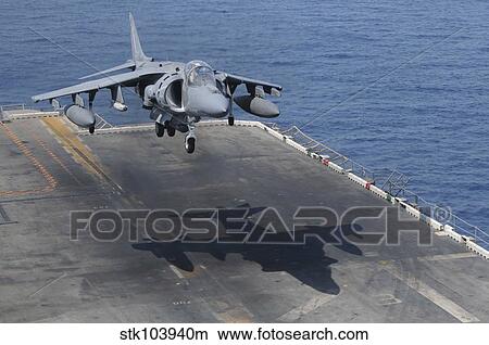 Picture - An AV-8B Harrier aircraft lands on the flight deck of USS Peleliu.. Fotosearch