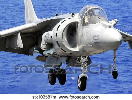 An AV-8B Harrier jet lands on the flight deck of USS Peleliu. View Large Photo Image Picture - An AV-8B Harrier jet lands on the flight deck of USS Peleliu.. Fotosearch