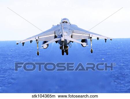 An AV-8B Harrier jet launches off the flight deck of USS Peleliu. View Large Photo Image Picture - An AV-8B Harrier jet launches off the flight deck of USS Peleliu.. Fotosearch