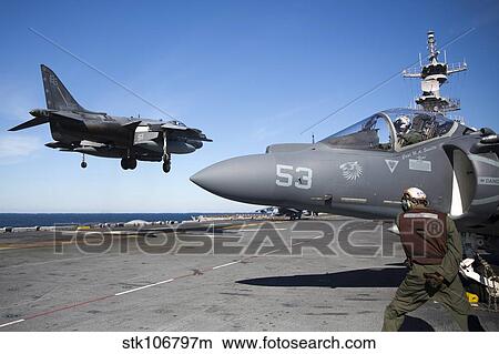 An AV-8B Harrier lands on the flight deck of USS Kearsarge. View Large Photo Image Picture - An AV-8B Harrier lands on the flight deck of USS Kearsarge.. Fotosearch