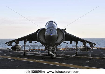 Picture - An AV-8B Harrier maneuvers on the flight deck of USS Kearsarge.. Fotosearch