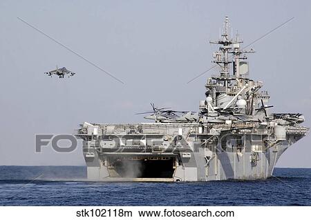 Picture - An AV-8B Harrier prepares to land on board amphibious assault ship USS Essex.. Fotosearch