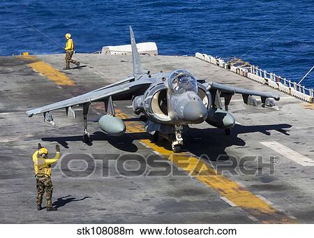 An AV-8B Harrier prepares to take off from the flight deck of the USS Kearsarge. View Large Photo Image Picture - An AV-8B Harrier prepares to take off from the flight deck of the USS Kearsarge.. Fotosearch