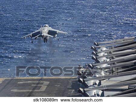 An AV-8B Harrier takes off from the flight deck of the USS Kearsarge. View Large Photo Image Picture - An AV-8B Harrier takes off from the flight deck of the USS Kearsarge.. Fotosearch
