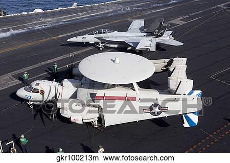 An E-2C Hawkey and an F/A-18 Super Hornet aboard USS Dwight D. Eisenhower. View Large Photo Image Picture - An E-2C Hawkey and an F/A-18 Super Hornet aboard USS Dwight D. Eisenhower.. Fotosearch
