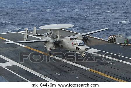 An E-2C Hawkeye is recovered during flight deck operations aboard USS Theodore Roosevelt. View Large Photo Image Picture - An E-2C Hawkeye is recovered during flight deck operations aboard USS Theodore Roosevelt.. Fotosearch