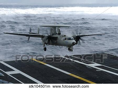 An E-2C Hawkeye lands aboard the aircraft carrier USS Dwight D. Eisenhower. View Large Photo Image Picture - An E-2C Hawkeye lands aboard the aircraft carrier USS Dwight D. Eisenhower.. Fotosearch