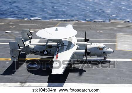 An E-2C Hawkeye lands aboard the aircraft carrier USS Nimitz. View Large Photo Image Picture - An E-2C Hawkeye lands aboard the aircraft carrier USS Nimitz.. Fotosearch