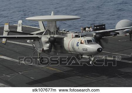 An E-2C Hawkeye lands aboard the aircraft carrier USS Nimitz. View Large Photo Image Picture - An E-2C Hawkeye lands aboard the aircraft carrier USS Nimitz.. Fotosearch