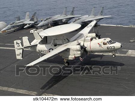 An E-2C Hawkeye lands on the flight deck of USS Theodore Roosevelt. View Large Photo Image Picture - An E-2C Hawkeye lands on the flight deck of USS Theodore Roosevelt.. Fotosearch