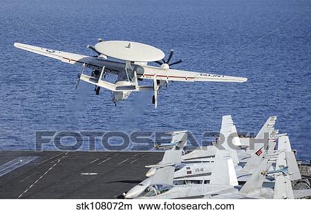 An E-2C Hawkeye launches off the flight deck of USS Nimitz. View Large Photo Image Picture - An E-2C Hawkeye launches off the flight deck of USS Nimitz.. Fotosearch
