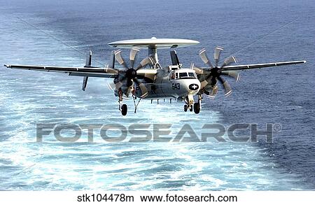 An E-2C Hawkeye prepares for an arrested landing. View Large Photo Image Picture - An E-2C Hawkeye prepares for an arrested landing.. Fotosearch
