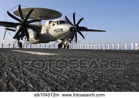 Picture - An E-2C Hawkeye sits on the flight deck of USS Abraham Lincoln while sailors man the rails.. Fotosearch