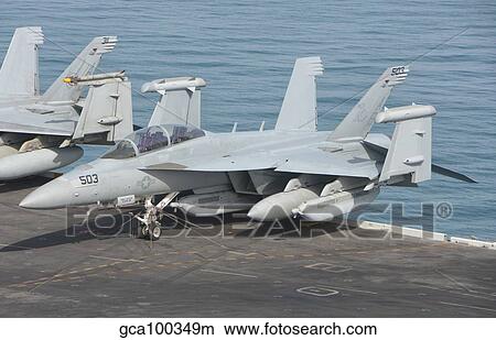 An EA-18G Growler aboard teh aircraft carrier USS Theodore Roosevelt. View Large Photo Image Picture - An EA-18G Growler aboard teh aircraft carrier USS Theodore Roosevelt.. Fotosearch
