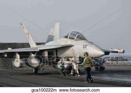An EA-18G Growler is guided into catapult aboard USS George H. W. Bush. View Large Photo Image Picture - An EA-18G Growler is guided into catapult aboard USS George H. W. Bush.. Fotosearch