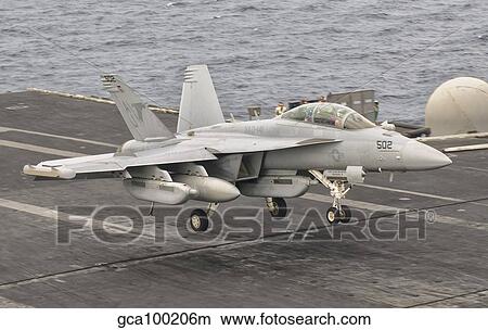 An EA-18G Growler landing on the flight deck of USS George H. W. Bush. View Large Photo Image Picture - An EA-18G Growler landing on the flight deck of USS George H. W. Bush.. Fotosearch