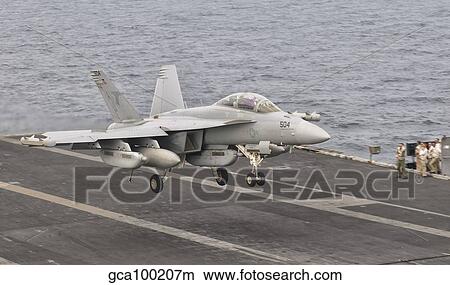 Picture - An EA-18G Growler landing on the flight deck of USS George H. W. Bush.. Fotosearch