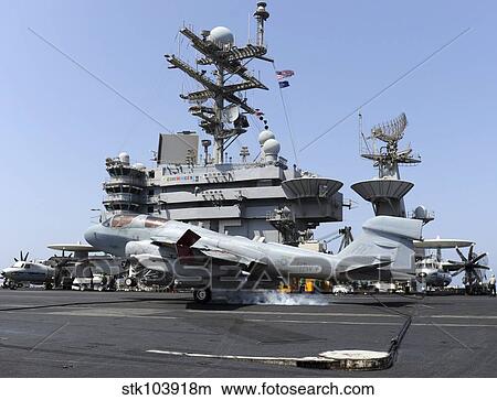 An EA-6B Prowler catches an arresting wire during landing. View Large Photo Image Picture - An EA-6B Prowler catches an arresting wire during landing.. Fotosearch