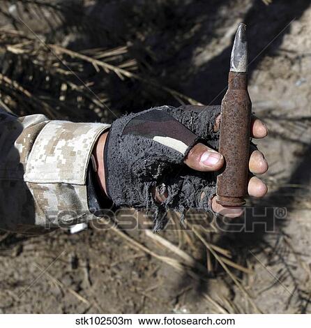An engineer displays a bullet found near a weapons cache. View Large Photo Image Picture - An engineer displays a bullet found near a weapons cache.. Fotosearch