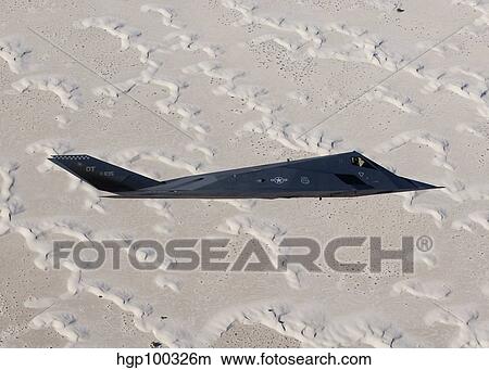 An F-117 Nighthawk flies over White Sands National Monument, New Mexico. View Large Photo Image Picture - An F-117 Nighthawk flies over White Sands National Monument, New Mexico.. Fotosearch
