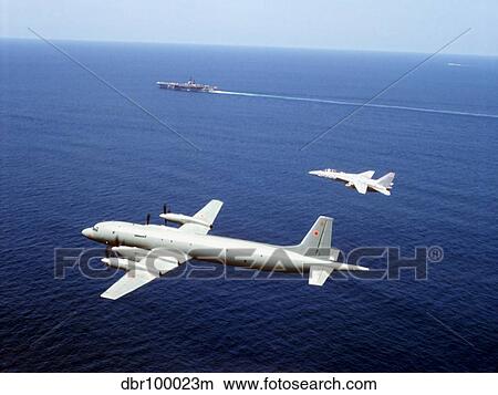 Picture - An F-14 Tomcat fighter escorts a Soviet Il-38 patrol aricraft over the Indian Ocean.. Fotosearch